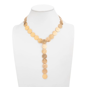 Detailed close-up of golden Y-shaped tassel necklace with hammered metal disc textures