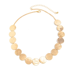 Detail of gold geometric circular metal plates on necklace with brushed texture finish