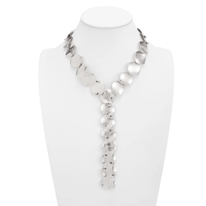 Macro detail of silver Y-shaped tassel necklace with brushed metal disc pendants
