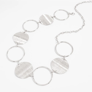 Detail of silver link body chain with brushed metal discs and polished hollow rings