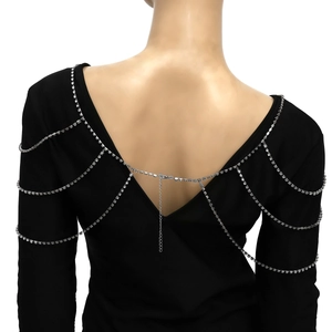 Macro detail of silver bridal shoulder chain featuring three-tier sparkling rhinestone fringe
