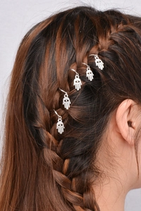 Detailed view of silver Hamsa Hand hair rings on braided dreadlocks for hip-hop style