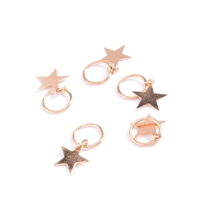 Detailed close-up of five rose gold star charms for hip-hop braids and hair accessories