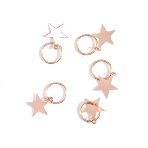 Detailed view of five gold star charms with rings for dreadlocks and hair styling