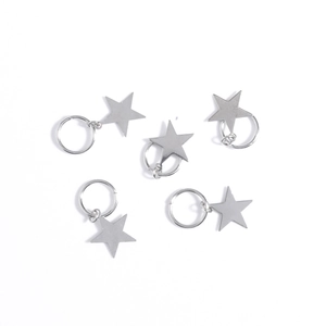 Detail of five silver star-shaped metal hair rings for braids and DIY jewelry crafts