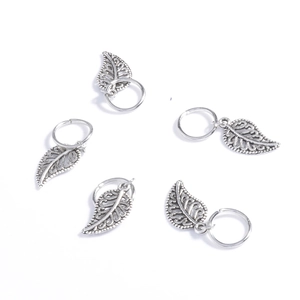 Close-up of five silver leaf charms for dreadlocks and hair braids accessories