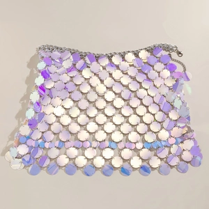 Detail of colorful sequins and hollow mesh structure with metal chain on the body chain