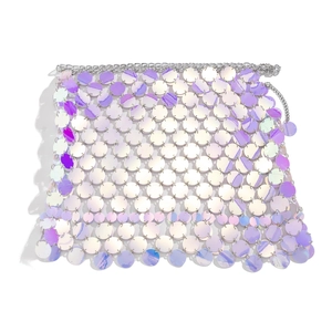 Macro detail of iridescent sequins and silver metal rings on a party body chain