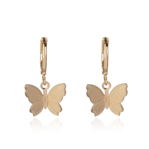 Detail of golden butterfly pendant earrings with round hoops and textured wings