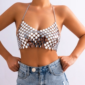 Detail of silver sequin halter body chain with metallic discs on a female model