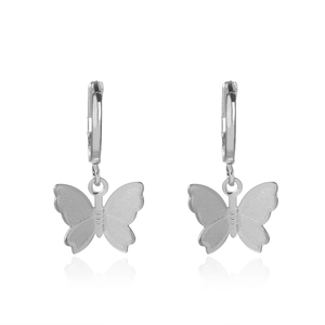 Detail view of silver butterfly earrings with intricate mesh texture and hoop closures