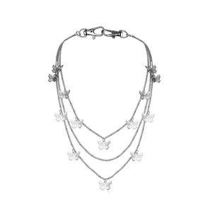 Close-up of triple-layered silver chain with butterfly pendants and lobster clasps