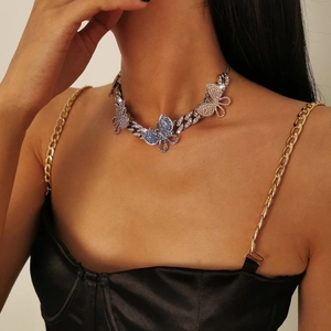 Detail of silver Cuban chain necklace with colorful gradient rhinestone butterfly pendants