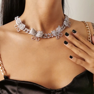Close-up of hip-hop silver Cuban chain necklace with a large crystal butterfly pendant
