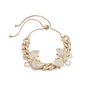 Detail of adjustable gold Cuban chain anklet featuring sparkling butterfly crystal charms