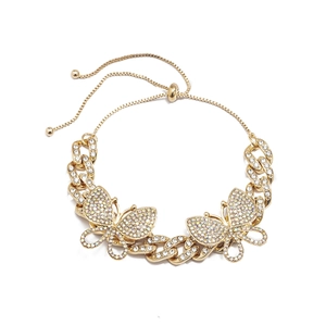 Detail of gold Cuban chain anklet featuring sparkling rhinestone butterfly charms