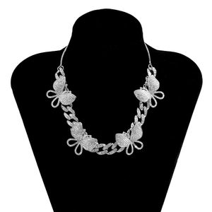 Detailed view of silver Cuban link necklace with four iced-out butterfly pendants