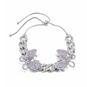 Detailed shot of butterfly charm with purple rhinestones on silver Cuban link anklet