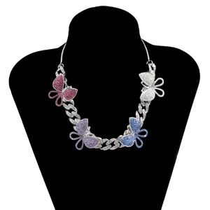 Detailed shot of vibrant butterfly pendants on a sparkling rhinestone Cuban link necklace