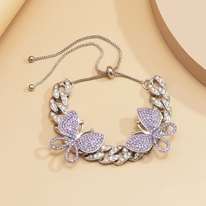 Detail of silver Cuban chain anklet with purple crystal butterflies and slider clasp