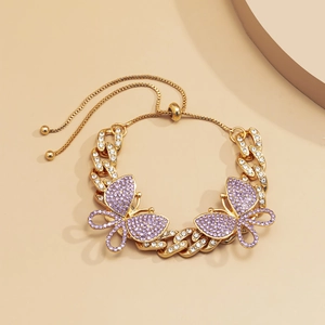 Detail of gold Cuban chain anklet with purple crystal butterflies and adjustable bolo clasp