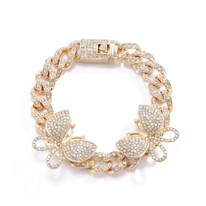 Detailed view of gold Cuban chain anklet featuring sparkling rhinestone butterfly charms