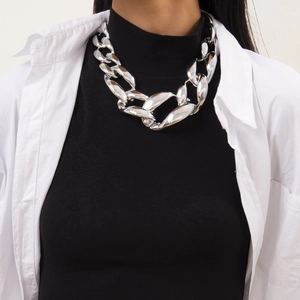 Close-up of chunky silver geometric chain necklace on model with edgy punk aesthetic
