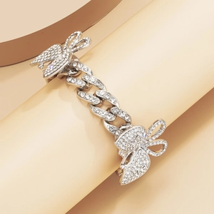 Close-up of silver Cuban link anklet with shimmering rhinestone butterfly pendants