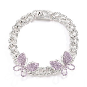 Close-up of iced-out Cuban chain anklet with purple crystal butterfly pendants detail