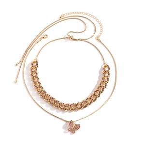 Goldenes Set aus Gliederkette und Schlangenkette mit pinkfarbenem Schmetterlingsanhänger