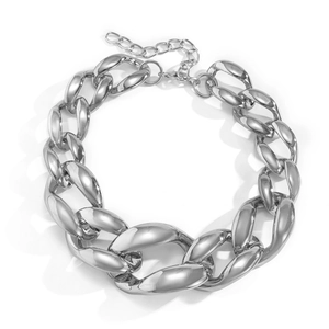 Macro view of chunky silver Cuban link necklace with polished finish and lobster clasp