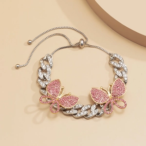 Close-up of a silver cuban chain anklet with pink crystal butterflies and adjustable bolo clasp