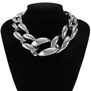 Detailed close-up of chunky silver chunky chain necklace on a black velvet display bust