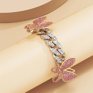 Detail of luxury Cuban chain anklet featuring sparkling pink rhinestone butterflies