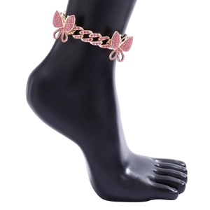 Close-up of pink crystal butterfly charms on a sparkling iced out Cuban link anklet
