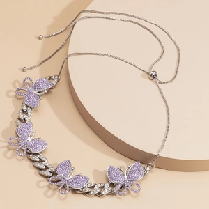 Detail of silver Cuban chain necklace with purple butterfly charms and adjustable slider