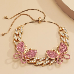 Detail of adjustable gold-plated Cuban chain bracelet with pink rhinestone butterflies