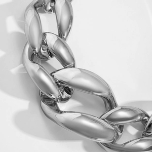 Macro shot of polished silver punk chunky chain link with reflective metallic finish