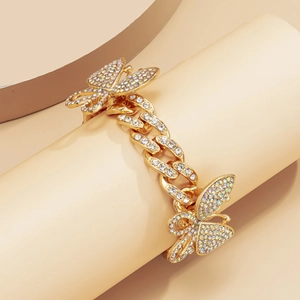 Detail of gold Cuban chain anklet with AB rhinestones and butterfly charms for women