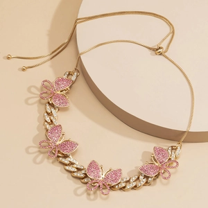 Detail of gold Cuban chain link necklace with pink rhinestone butterflies and adjustable clasp