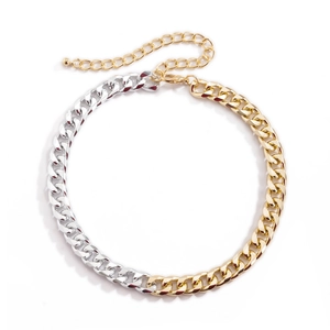Detailed close-up of a two-tone gold and silver Cuban link necklace with lobster clasp