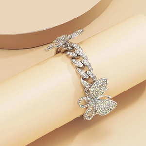 Detailed view of silver Cuban link anklet featuring luxury iced out crystal butterflies