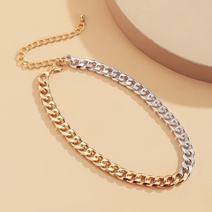 Detail of mixed gold and silver chunky chain necklace with lobster clasp and ball pendant