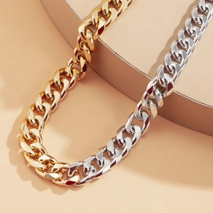 Close-up of two-tone gold and silver chunky Cuban link necklace in hip-hop punk style