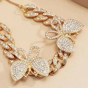 Close-up of golden Cuban link anklet with shimmering pavé diamond butterfly charms