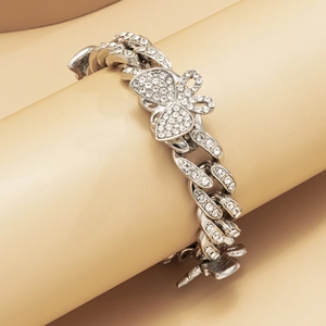 Macro view of silver butterfly cuban link anklet with shimmering pavé rhinestones