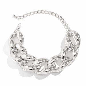 Macro detail of chunky silver chain necklace with polished links and lobster clasp