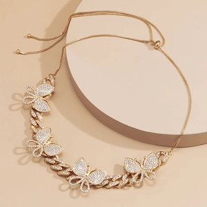 Detailed view of adjustable gold butterfly necklace with shimmering pavé crystal stones