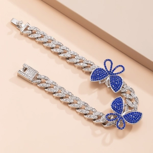 Detailed close-up of hip hop Cuban chain anklet with sparkling blue crystal butterflies