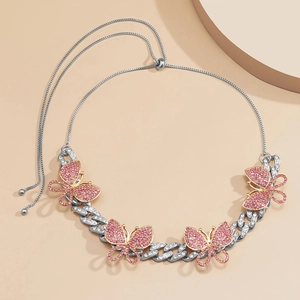 Close-up of pink crystal butterfly pendants on a silver Cuban link adjustable necklace